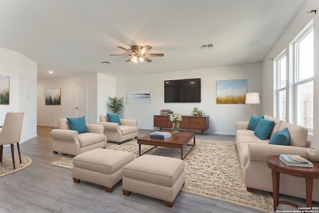 living room featuring light wood-type flooring and ceiling fan