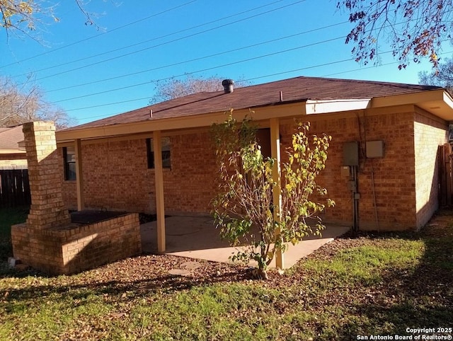 view of side of home with a patio area