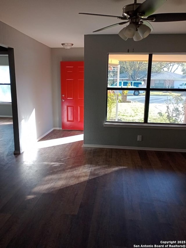 interior space with ceiling fan and dark wood-type flooring