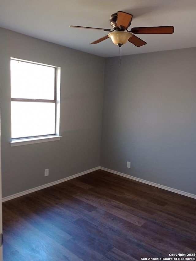 unfurnished room with ceiling fan and dark wood-type flooring