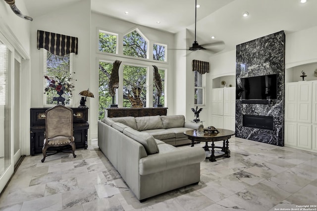 living room featuring a towering ceiling and ceiling fan