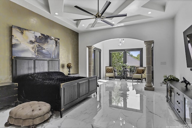 bedroom featuring decorative columns and ceiling fan with notable chandelier