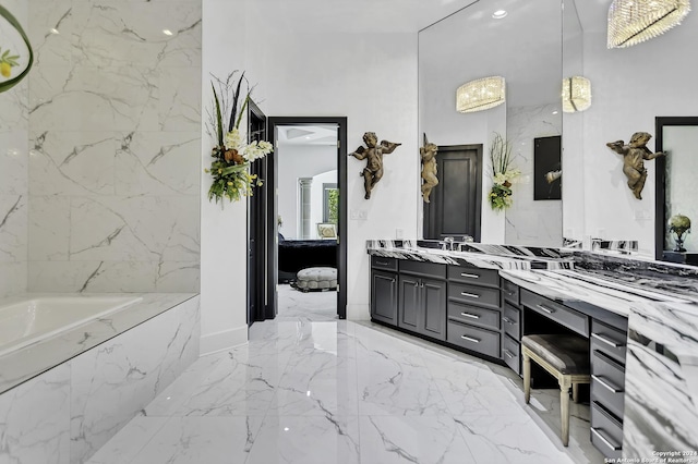 bathroom with vanity and a relaxing tiled tub