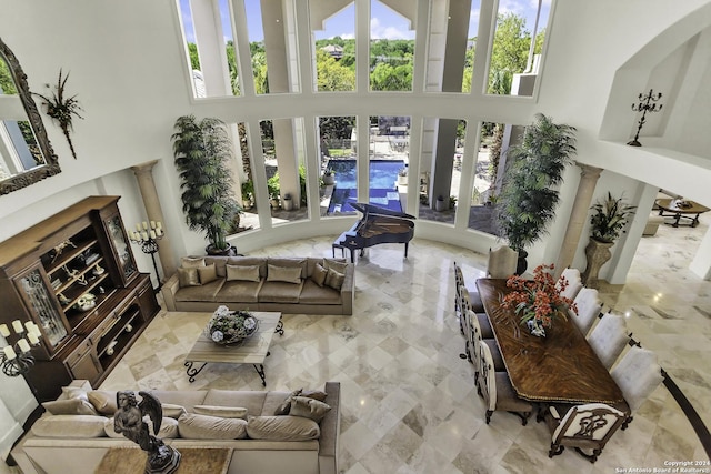 living room featuring a towering ceiling