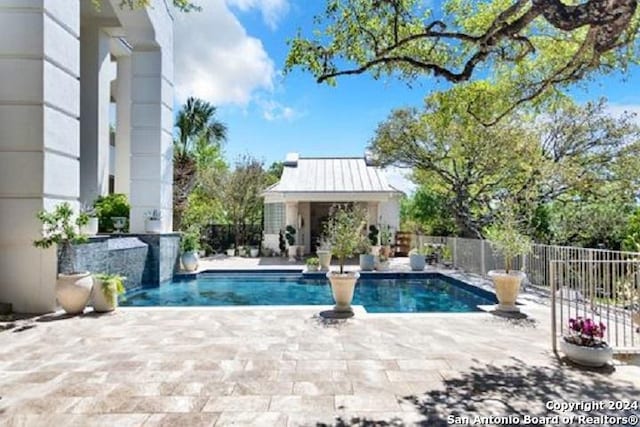 view of swimming pool with a patio area