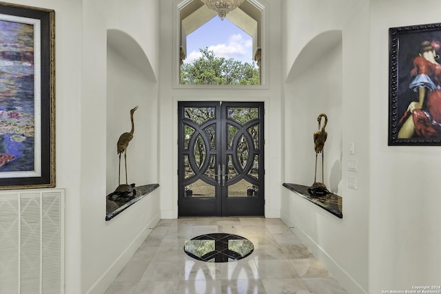 foyer entrance with french doors and a high ceiling