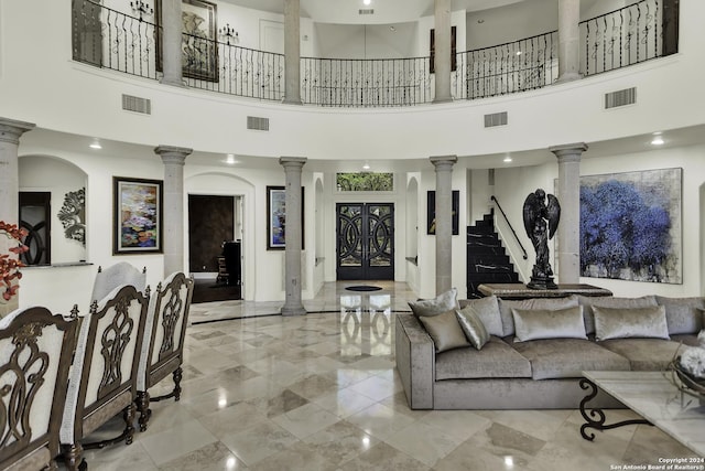 living room with a high ceiling and french doors