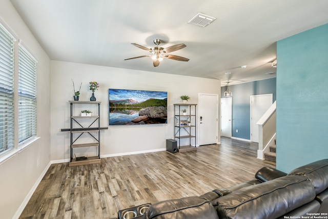 living room with ceiling fan and wood-type flooring