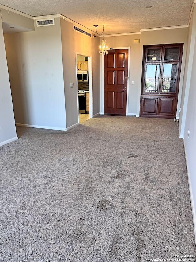 unfurnished living room with crown molding, light colored carpet, a textured ceiling, and an inviting chandelier