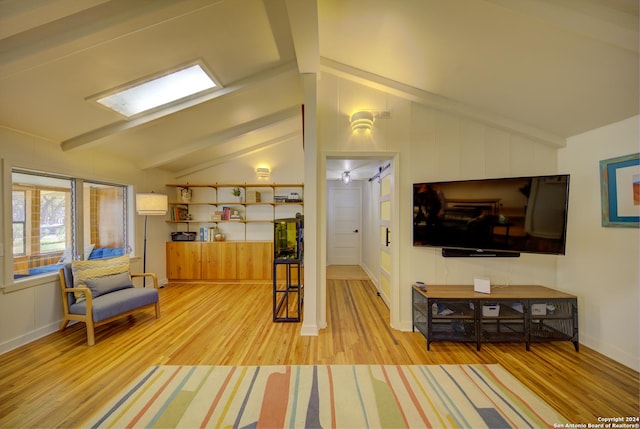 living room featuring light hardwood / wood-style floors and vaulted ceiling with beams