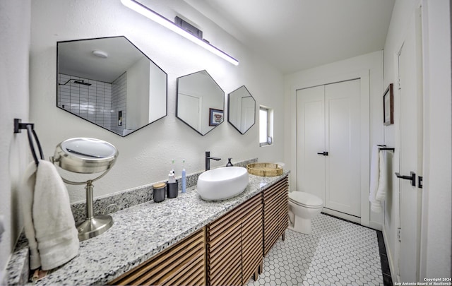 bathroom with tile patterned floors, vanity, and toilet