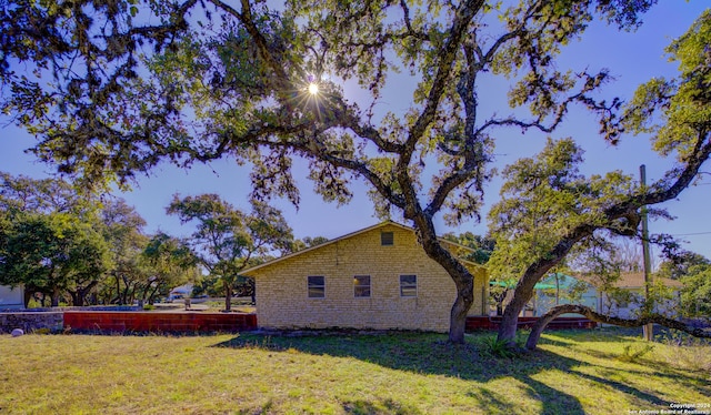 view of property exterior featuring a lawn