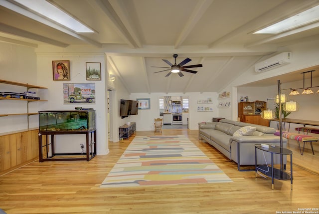 living room featuring ceiling fan, light hardwood / wood-style floors, vaulted ceiling with beams, and an AC wall unit