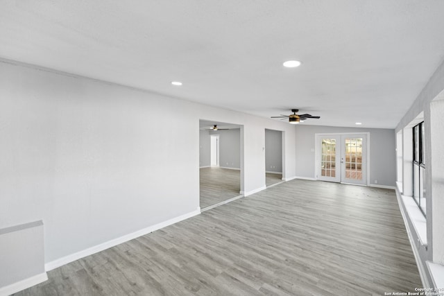 spare room with french doors, light hardwood / wood-style flooring, and ceiling fan