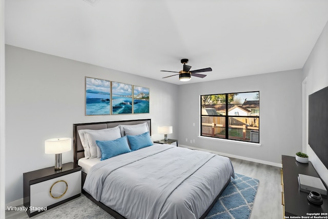 bedroom with ceiling fan and hardwood / wood-style flooring