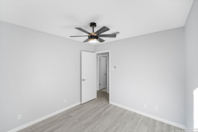 empty room with light wood-type flooring and ceiling fan