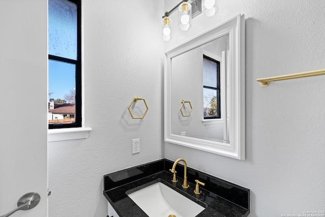 bathroom with plenty of natural light and vanity