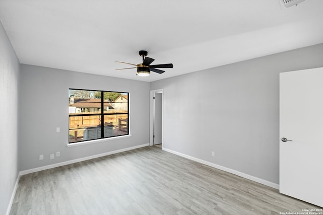 spare room featuring light hardwood / wood-style floors and ceiling fan