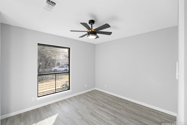 empty room with ceiling fan and wood-type flooring