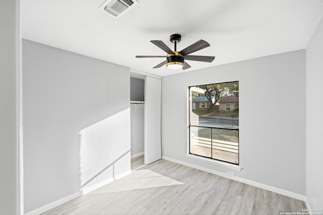 unfurnished room featuring plenty of natural light, light hardwood / wood-style floors, and ceiling fan