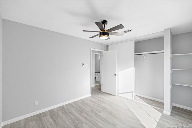 unfurnished bedroom with ceiling fan, light hardwood / wood-style flooring, and a closet