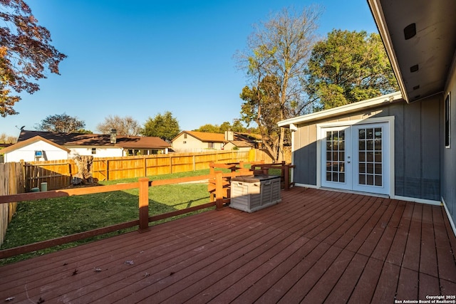 wooden terrace featuring a yard and french doors