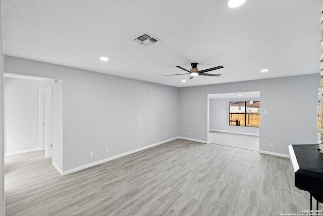 unfurnished living room with ceiling fan and light wood-type flooring