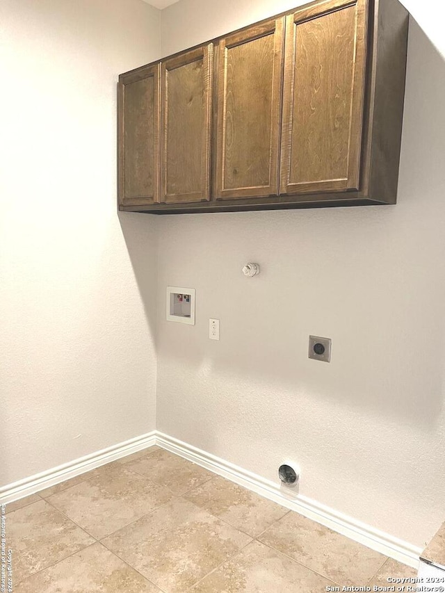 laundry area with electric dryer hookup, cabinets, gas dryer hookup, and hookup for a washing machine