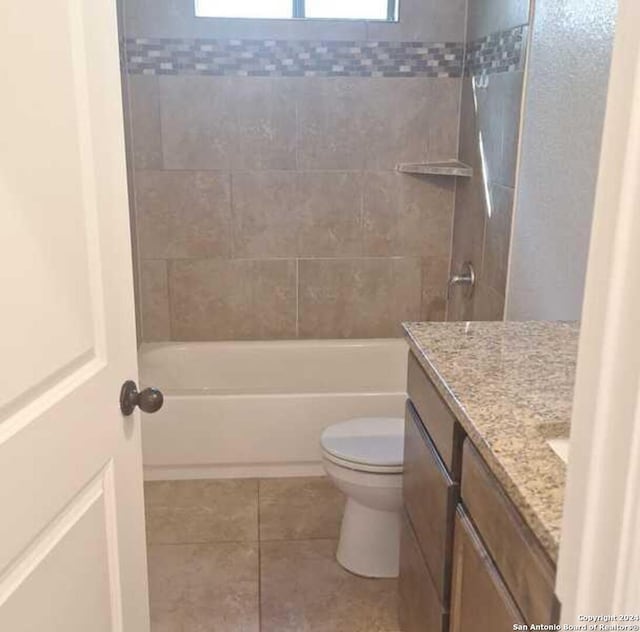 full bathroom with tile patterned flooring, vanity, toilet, and tiled shower / bath