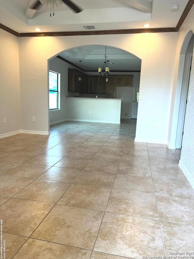 spare room featuring ceiling fan and ornamental molding