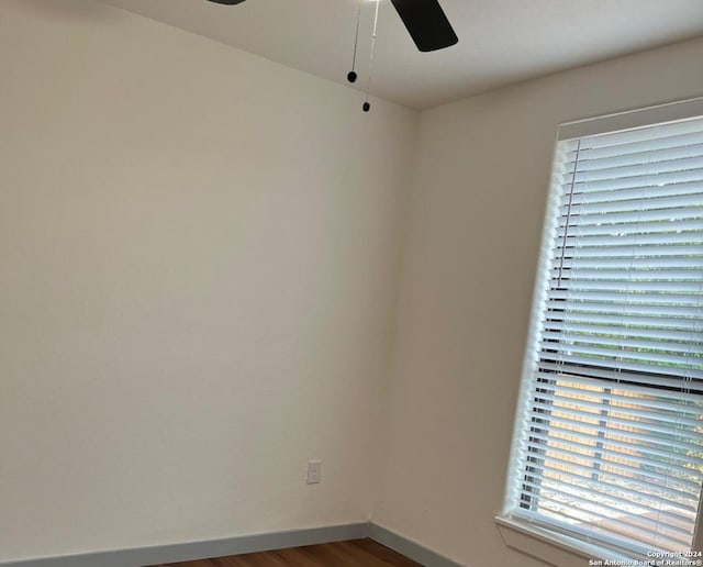 spare room with hardwood / wood-style flooring and ceiling fan