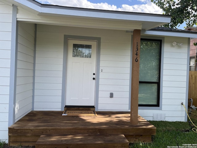 view of exterior entry featuring covered porch