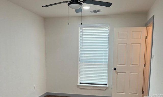 spare room with hardwood / wood-style floors and ceiling fan