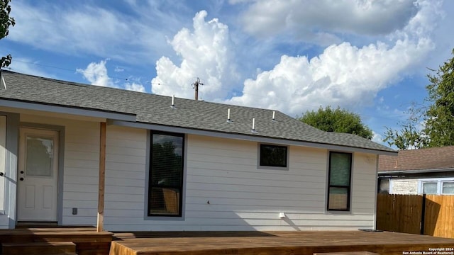 rear view of property featuring a wooden deck