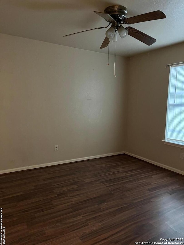 unfurnished room featuring ceiling fan and dark wood-type flooring