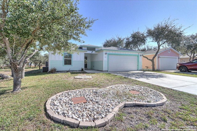 ranch-style home with cooling unit, a garage, and a front lawn