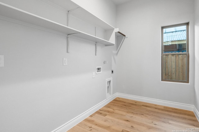 laundry area featuring electric dryer hookup, gas dryer hookup, light hardwood / wood-style flooring, and washer hookup