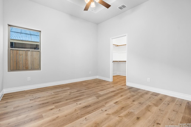 empty room with light hardwood / wood-style flooring and ceiling fan