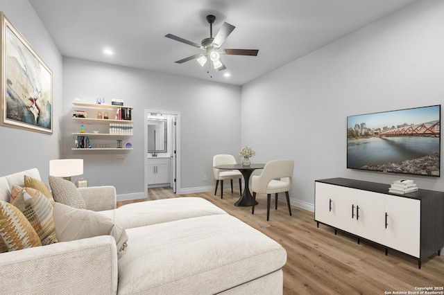 living room with light wood-type flooring and ceiling fan