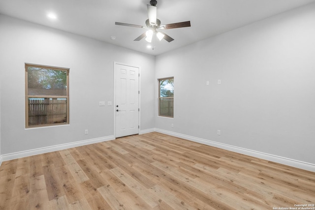 spare room with light hardwood / wood-style flooring and ceiling fan