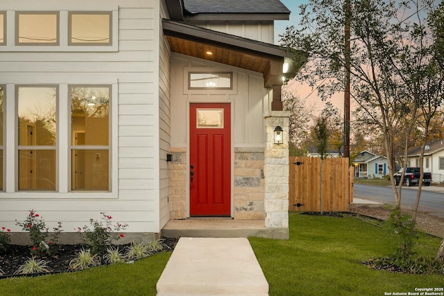 exterior entry at dusk with a lawn