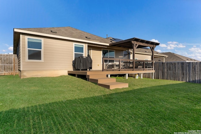 rear view of property featuring a pergola, a deck, and a lawn