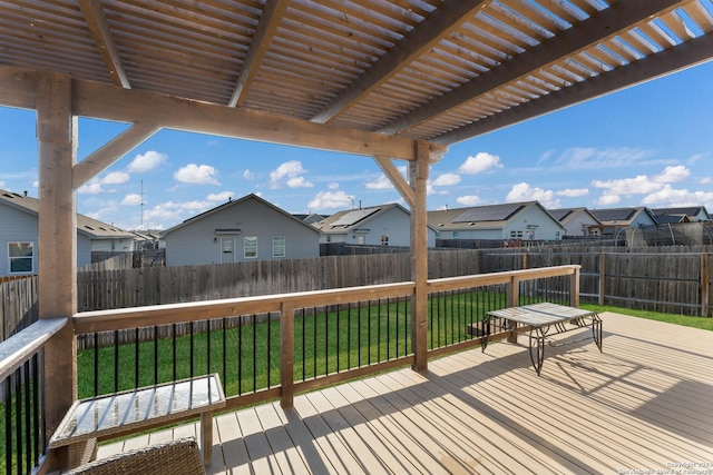 wooden deck featuring a lawn and a pergola