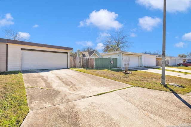 ranch-style home featuring a front lawn and a garage