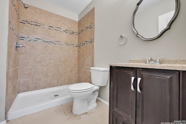 bathroom featuring vanity, toilet, and tiled shower