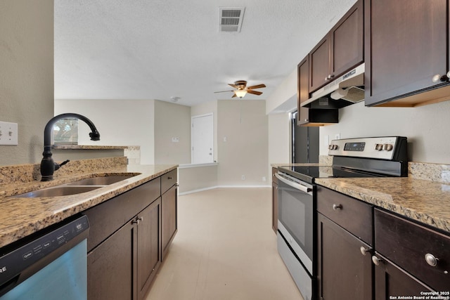 kitchen with dark brown cabinetry, light stone countertops, sink, and stainless steel appliances