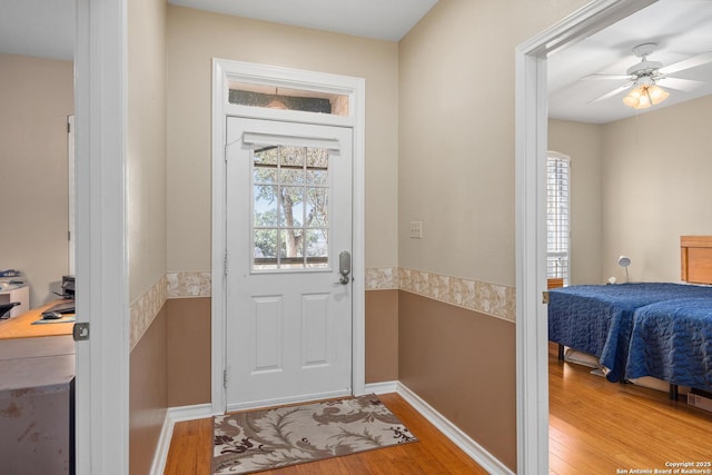 doorway to outside featuring hardwood / wood-style floors and ceiling fan