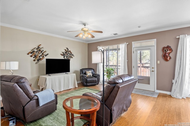 living room featuring ceiling fan, light hardwood / wood-style flooring, and crown molding