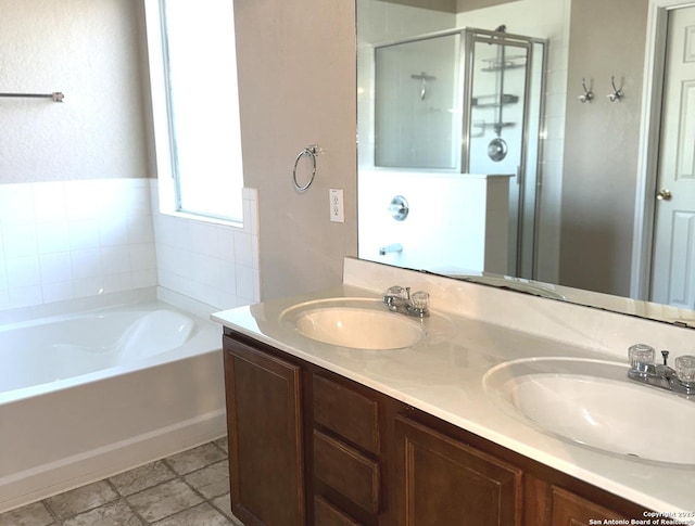 bathroom featuring vanity and independent shower and bath