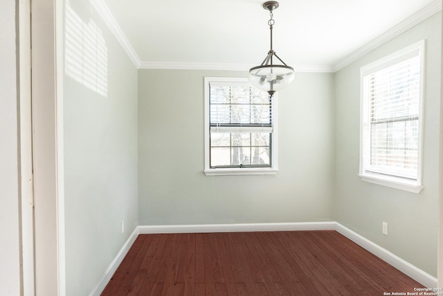 unfurnished room featuring ornamental molding, a notable chandelier, a healthy amount of sunlight, and wood-type flooring